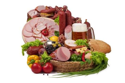 A composition of meat and vegetables with a pot full of beer isolated on white. File includes clipping path for easy background removing.