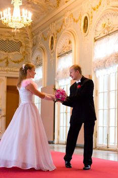 Bride and groom dancing indoors looking to each other