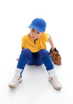 A young boy dressed in baseball tball sports clothing and wearing a leather glove mitt.  Sitting on white background.  