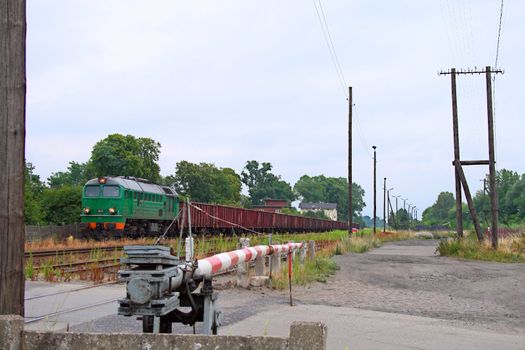Freight train waiting at station with the mechanical barriers