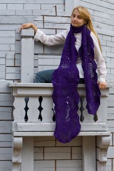 Portrait of the girl on the wooden balcony
