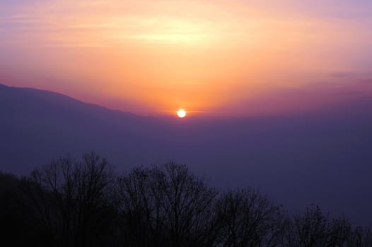 Scenery of sunset at mountains in winter