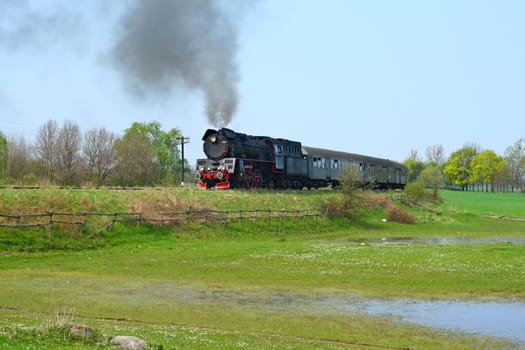 Steam retro train passing the countryside