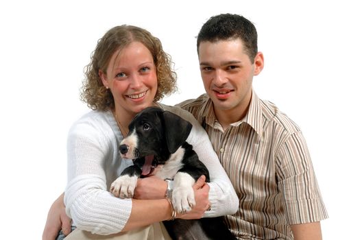 Portrait of a young happy couple and their sweet puppy.