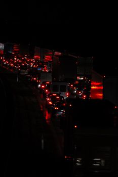 Heavy traffic. Many cars and trucks are waiting in a long line