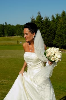 Bride in white dress with flower bouquet