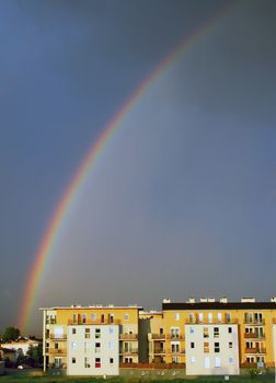 Rainbow after the storm over the modern buildings