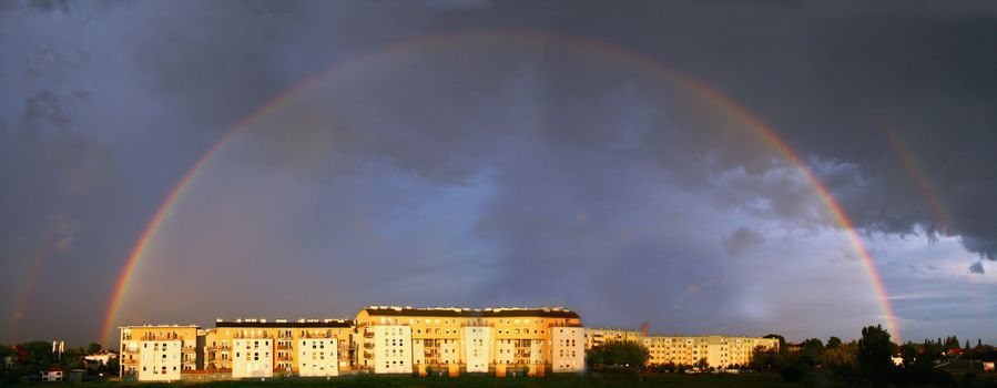 Panoramic view of the double rainbow over the city