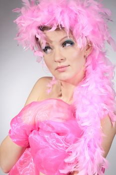 Studio shot of beatiful model with pink plumage