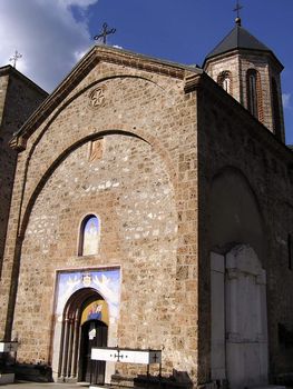 Front view of Raca monastery at Tara mountain in Serbia against clear blue sky.