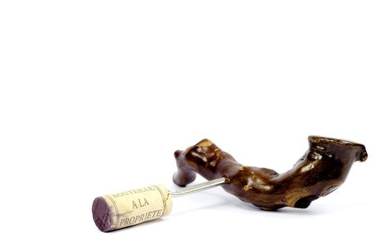 A freshly pulled cork from a wine bottle set on an isolated white background 