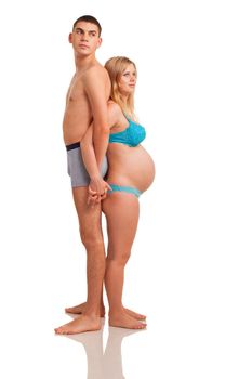 Pregnant woman with her husband looking forward. Studio shoot on white.