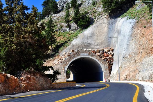 Travel photography: Mountain road passing through a tunnel in the island of 

Crete.