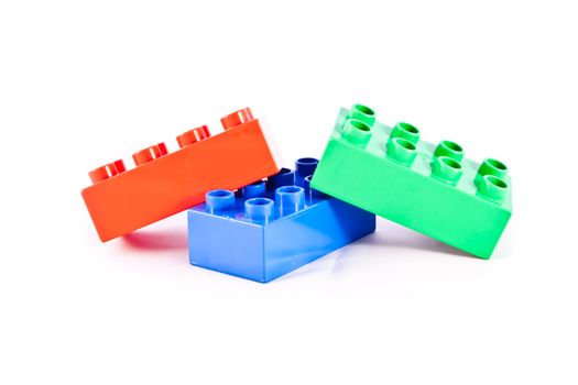 Plastic building blocks on white background. Bright colors.