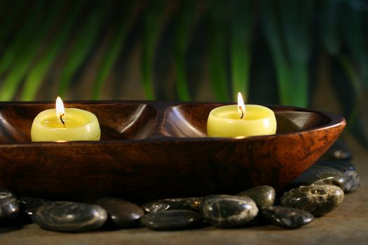 Massage stones and spa candles for wellness concept