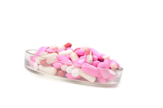 Shot of pink drugs (tablets) isolated on white