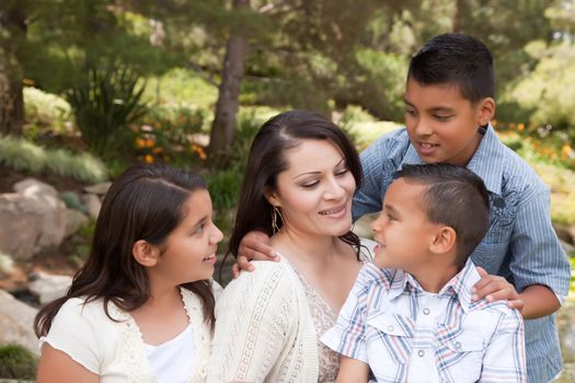 Happy Hispanic Mother and Children in the Park.