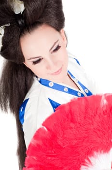 Portrait of the girl of the Asian appearance with a make-up under the geisha on a white background