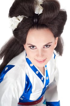 Portrait of the girl of the Asian appearance with a make-up under the geisha on a white background