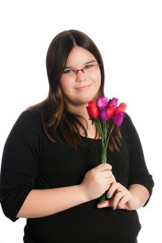 A young teen girl is holding a small bouquet of roses, isolated against a white background.