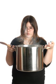 A young girl is holding a large pot of steaming soup, isolated against a white background.