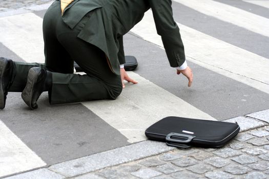 Man falling in the street when crossing the road (This man is a model)