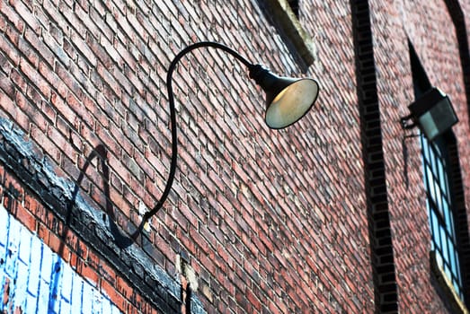 Interesting old brick industrial building with a curved lamp