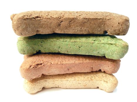 Isolated stack of colored dog treats shaped like bones