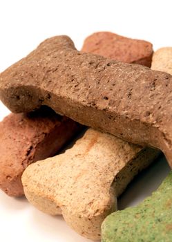 Close up of colorful dog treats over a white background