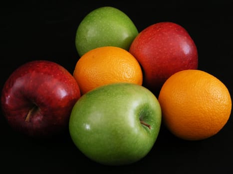 Granny Smith and Jonathan apples with a pair of navel oranges.