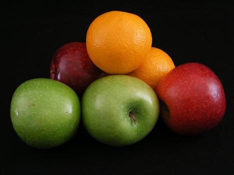 Granny Smith and Jonathan apples with a pair of navel oranges.