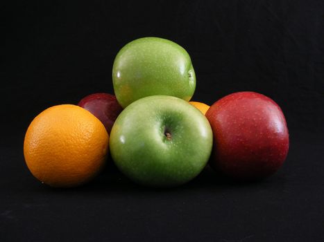 Granny Smith and Jonathan apples with a pair of navel oranges.