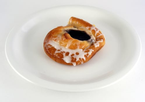 A blueberry danish on a plate.