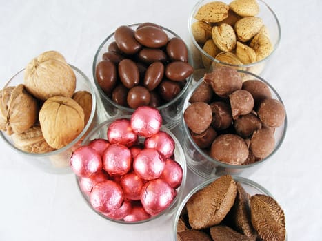 Candy and nuts displayed against an off-white background.