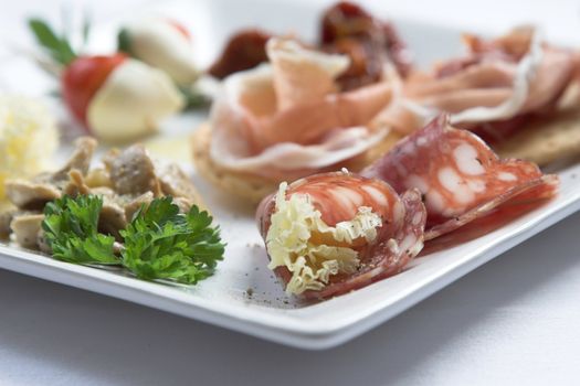 Italian famous anti pasti dish, made up with saucage, cheese, tomatoes, parsley and parmaham