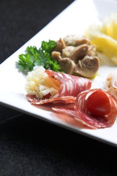 Plate of deliciously little nibbles of famous Italian antipasti