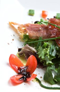 Season salad with crispy parma ham and decorated with a tomatoe flower