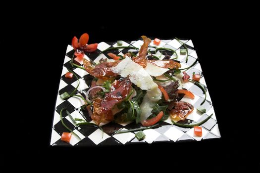 healthy salad on a checkered plate on black background