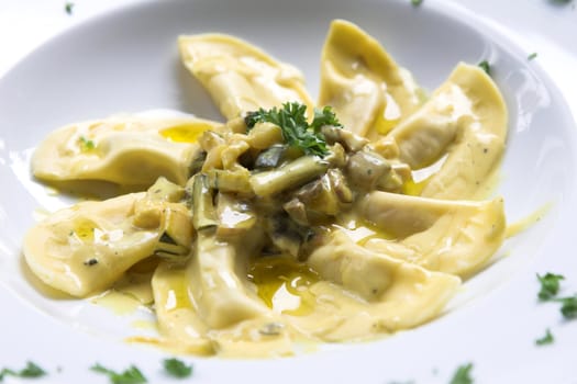 Italian pasta dish with filled pasta, courgette, mushrooms and a creamy sauce topped with a little bit of parsley