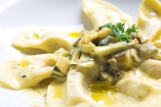 Beautiful italian pasta dish with mushrooms, courgette and decorated with a little bit of parsley on top