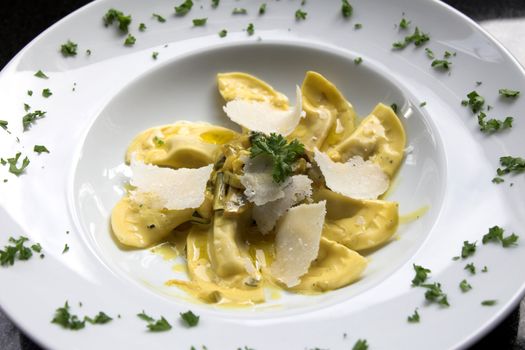 Beautiful pasta dish with filled pasta and a sauce made of mushrooms, courgette and cream