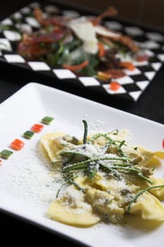 Delicious italian pasta dish with slices of courgette on top and sprinkled with parmesan cheese