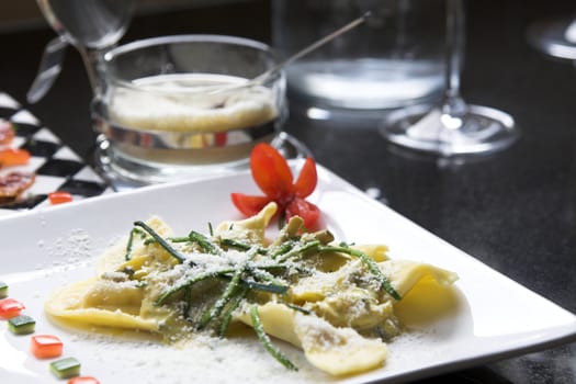 Italian pasta dish with slices of courgette and sprinkled with parmesan cheese