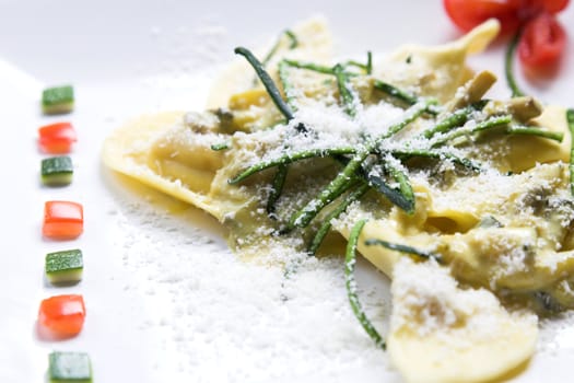 Delicious pasta dish covered with slices of courgette and sprinkled with parmesan cheese