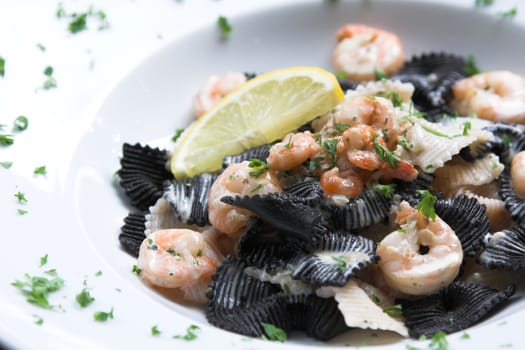 Delicious seafood pasta dish with tigerprawns, prawns and a lemon