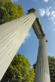 The remains of a Roman building standing isolated, dramatic and mysterious against the sky. Taken from a low viewpoint.