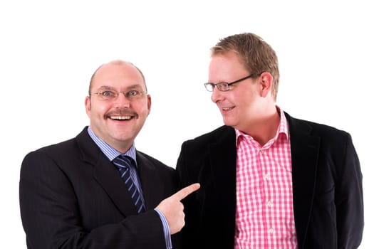 Two businessman standing next to each other; one pointing excitedly to the other