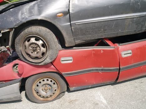 wracked car on top of another