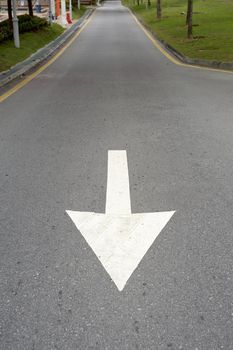 Down or backwards to drive towards the marker on the road.