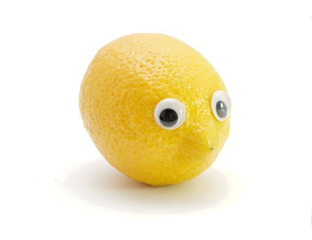 Funny lemon fruit with eyes on white background